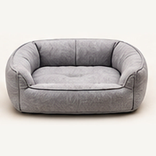 Cama acolchada gris para perros sobre fondo claro